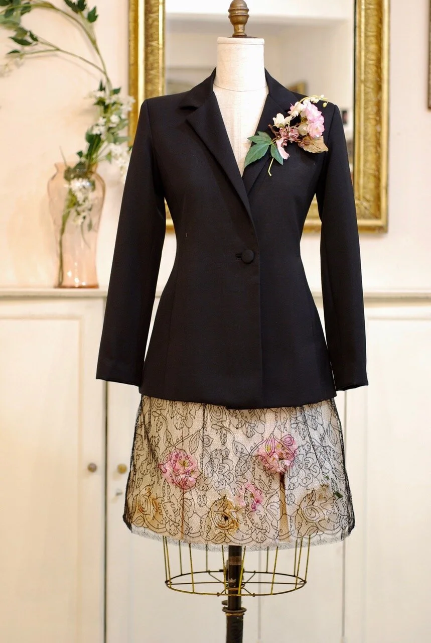 Black English wool jacket with flower and lace adorned silk shantung skirt