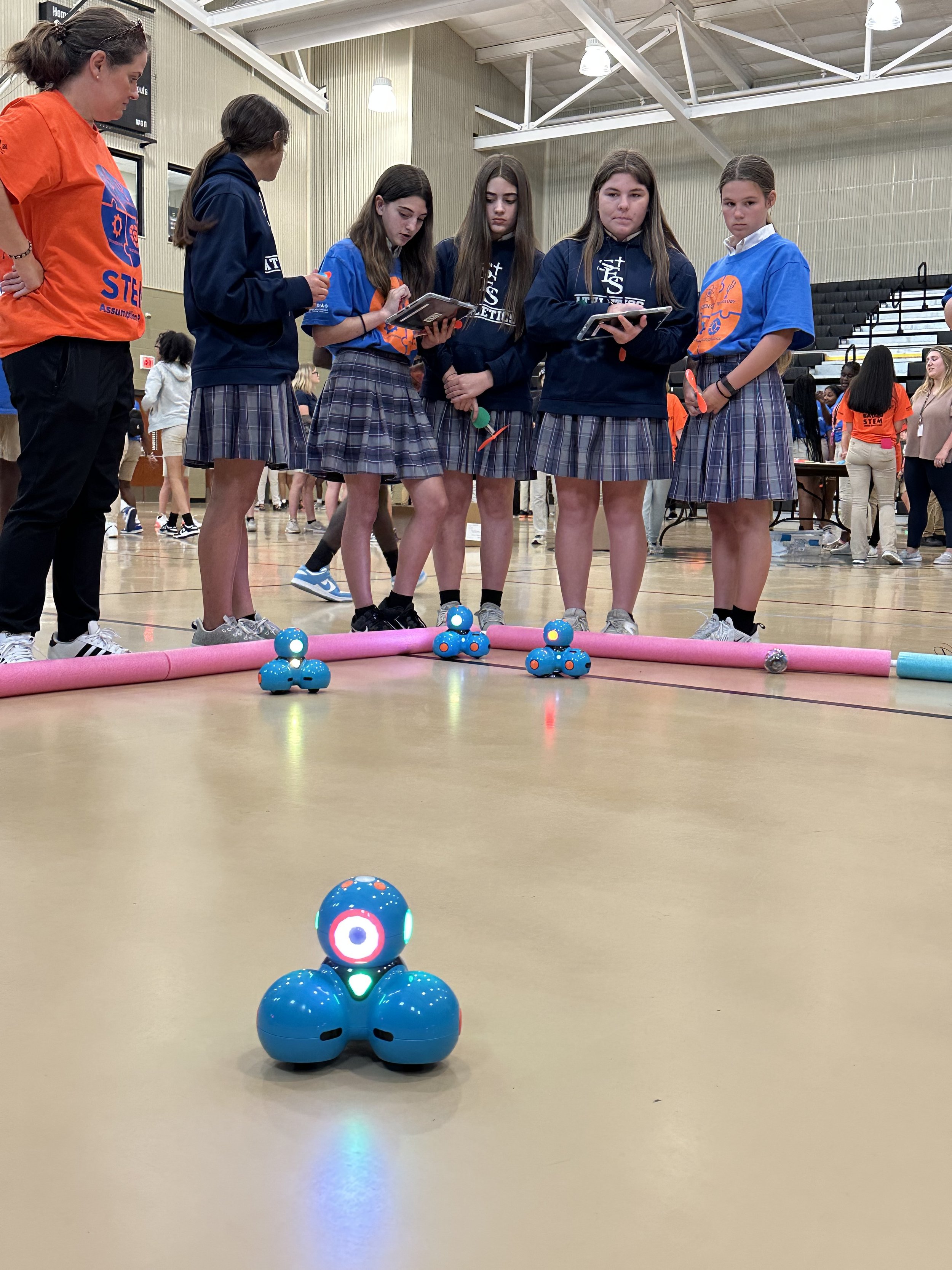  St. Elizabeth School Volunteer Danielle Blanchard, left, watches some of her school’s 7th graders work together to use software coding to remotely operate small robots during the Assumption Parish STEM Challenge Day. The students are, from left to r