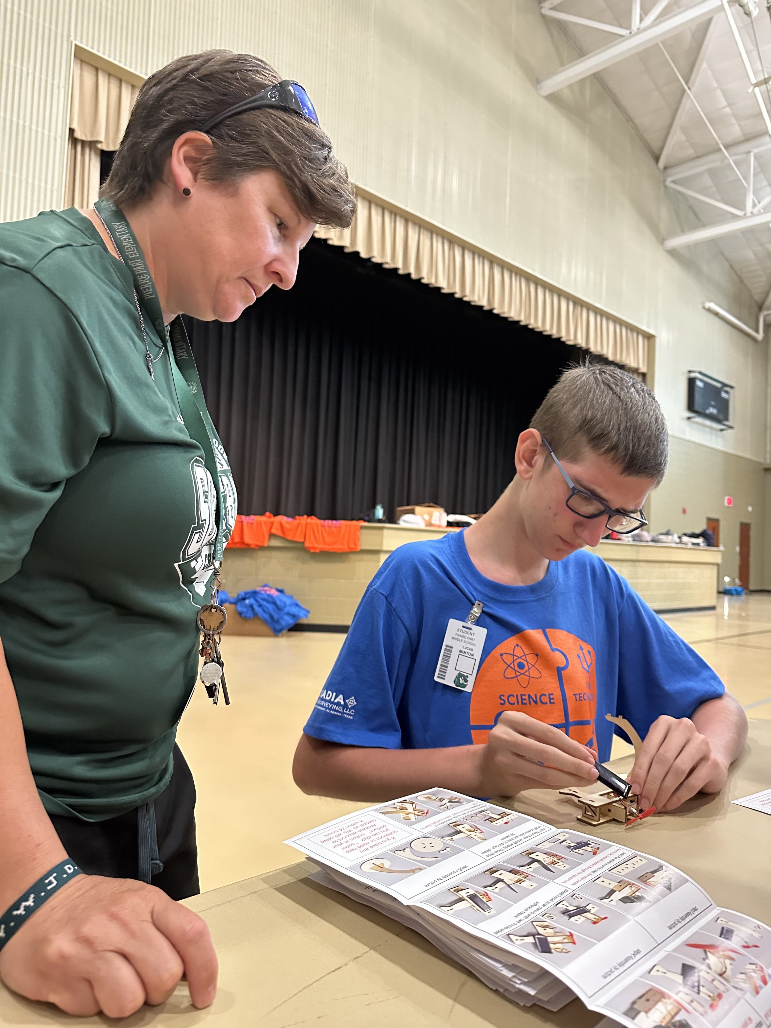  Pierre Part Elementary Teacher Christy Cavalier overlooks 7th Grader Lucas Minton as he puts together a solar-powered plane during the Assumption Parish STEM Challenge Day. 