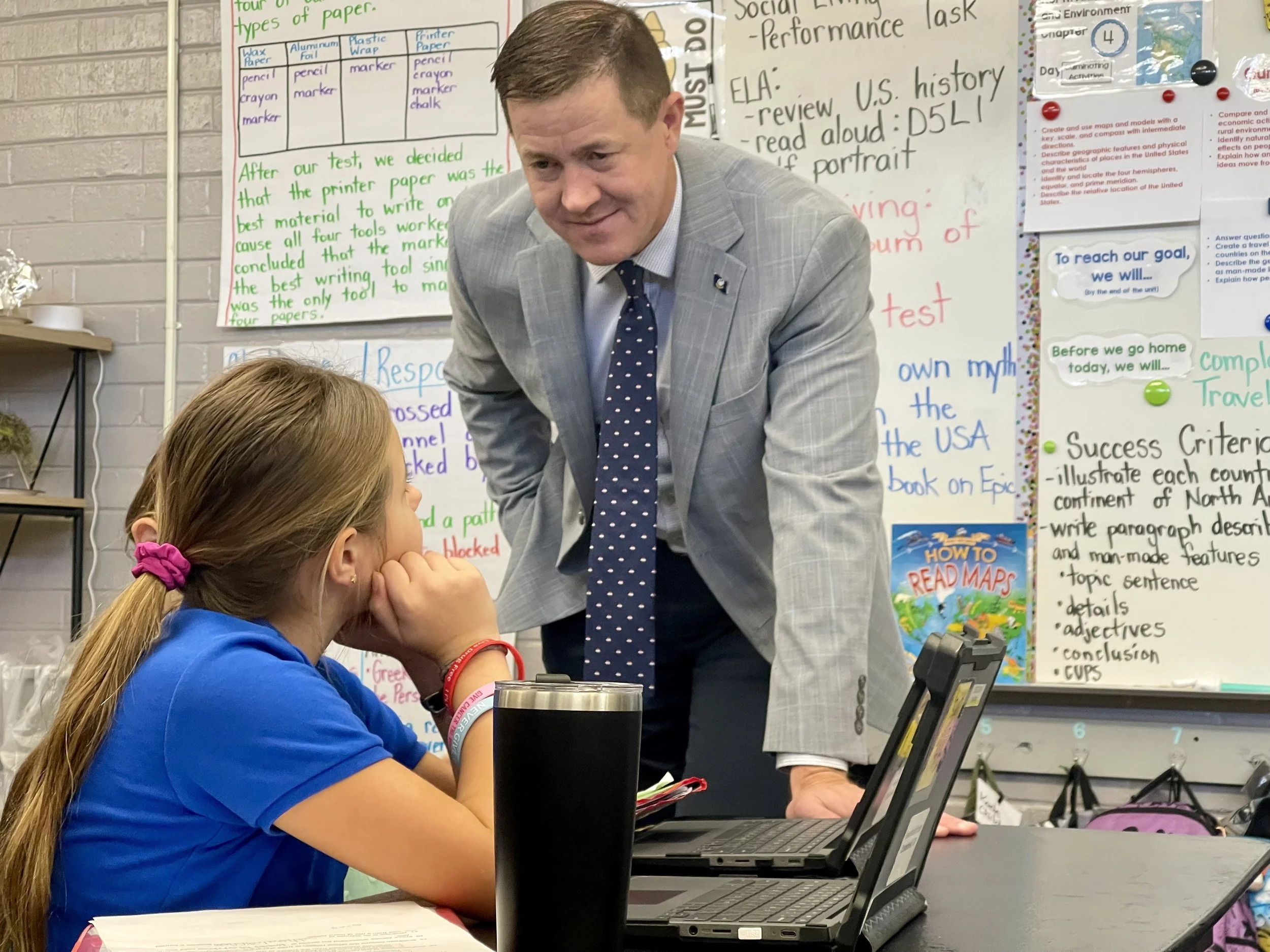  Louisiana State Superintendent of Education Dr. Cade Brumley visits with a student at Napoleonville Elementary during his recent visit. 