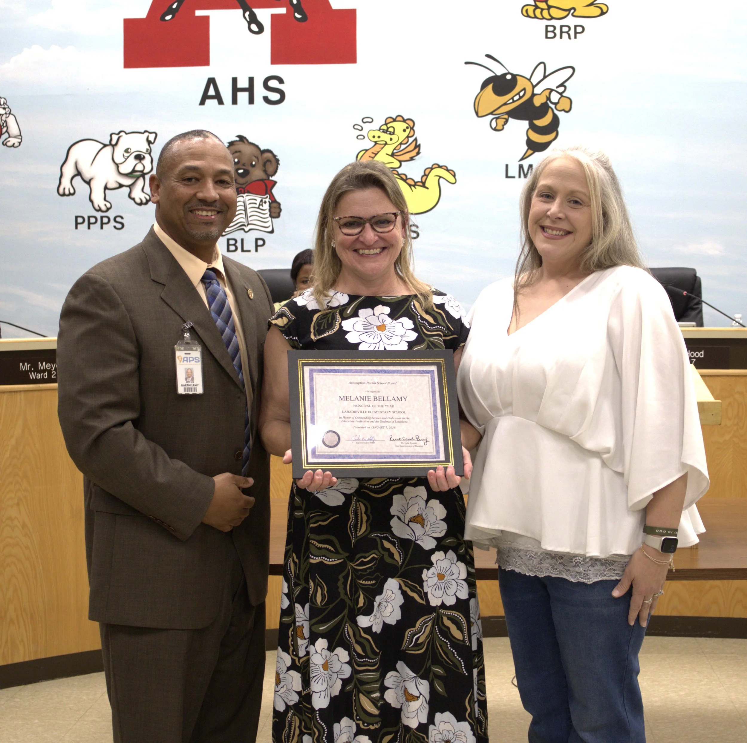  Assumption Parish School Superintendent Dr. John Barthelemy, left, and School Board President Bambi Hood, right, present Principal of the Year Melanie Bellamy, Labadieville Elementary, with a framed certificate to recognize her as this year’s Assump