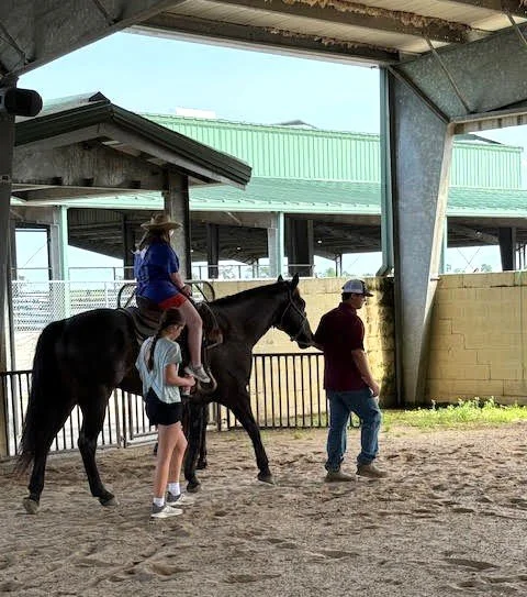  4-H member Vera Trosclair from Napoleonville Elementary School and her horse Minnie, along with CRA Representative Aaron Matherne volunteered to give rides to participants of the Special Needs Rodeo. 