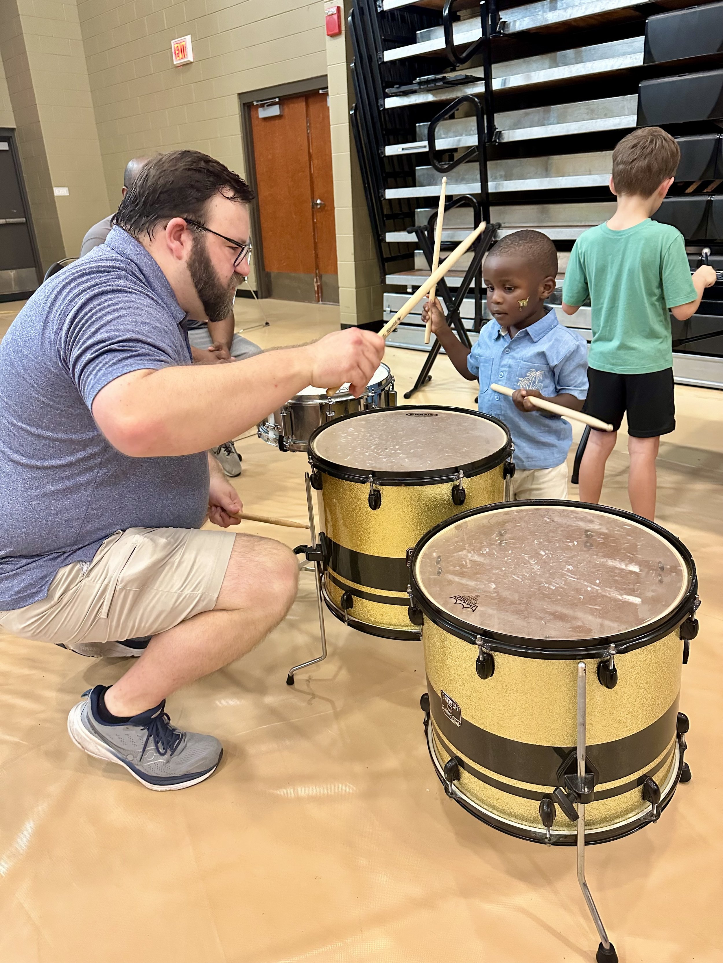  Assumption Parish School Board Member Joshua Hebert shows 3-year-old Jakyrie Francis how to strike the snare drums with his drumsticks during the Early Childhood Day in Assumption Parish. Hebert is also a member of the Assumption Foundation for the 