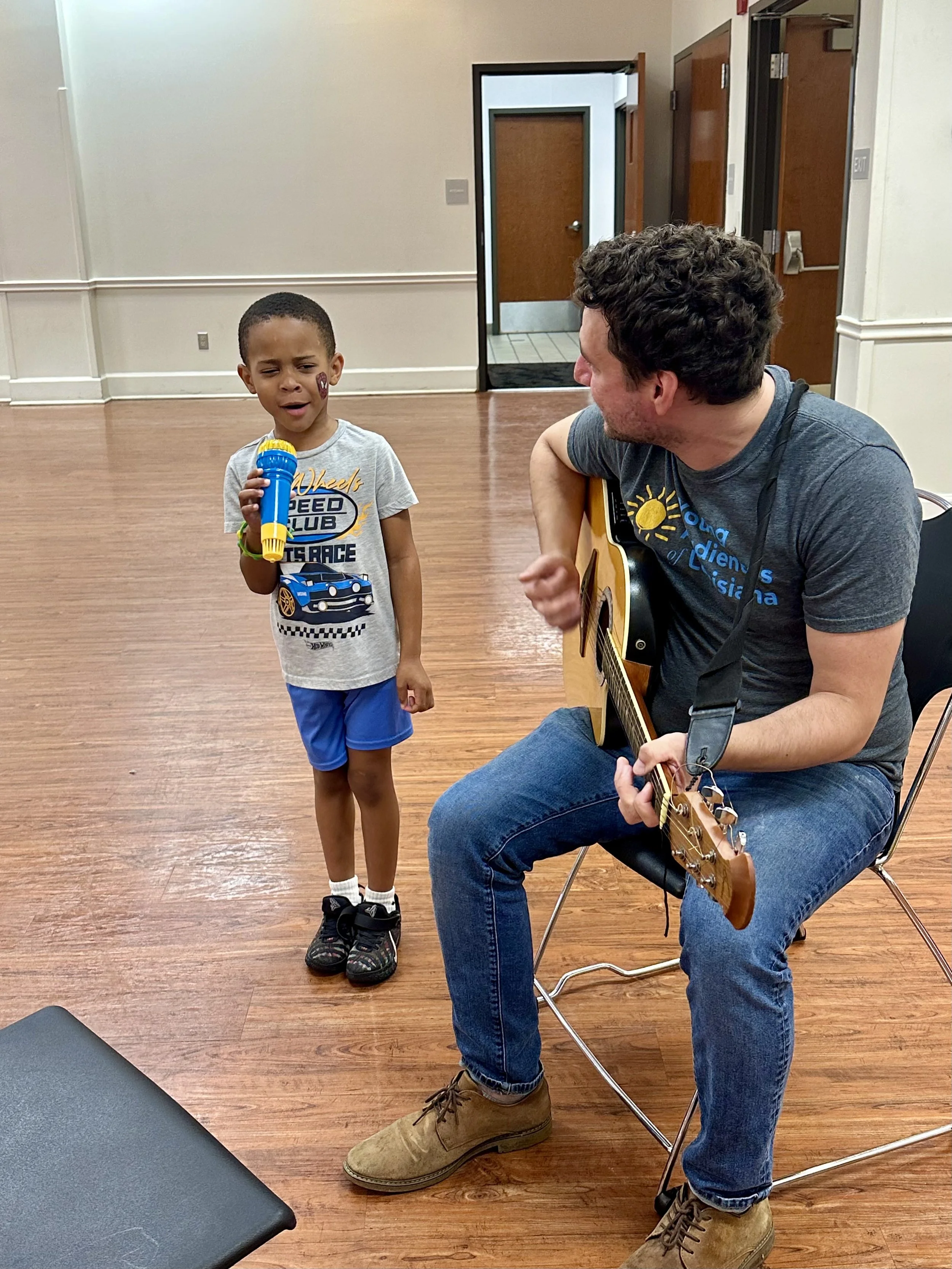  Five-year-old Joseph Starks, Jr., sings along with guitarist Sean Fullon during his visit to the Early Childhood Day in Assumption Parish. Fullon is on the teaching staff at Young Audiences of Louisiana. 