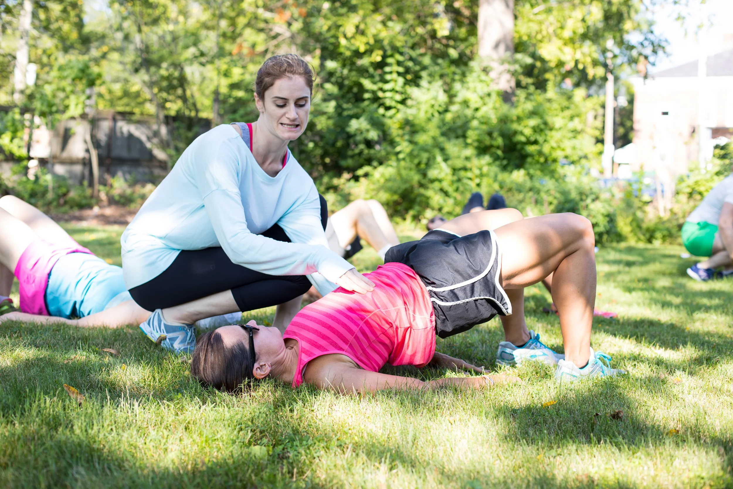 Lindsay working with a participant who is performing a bridge.