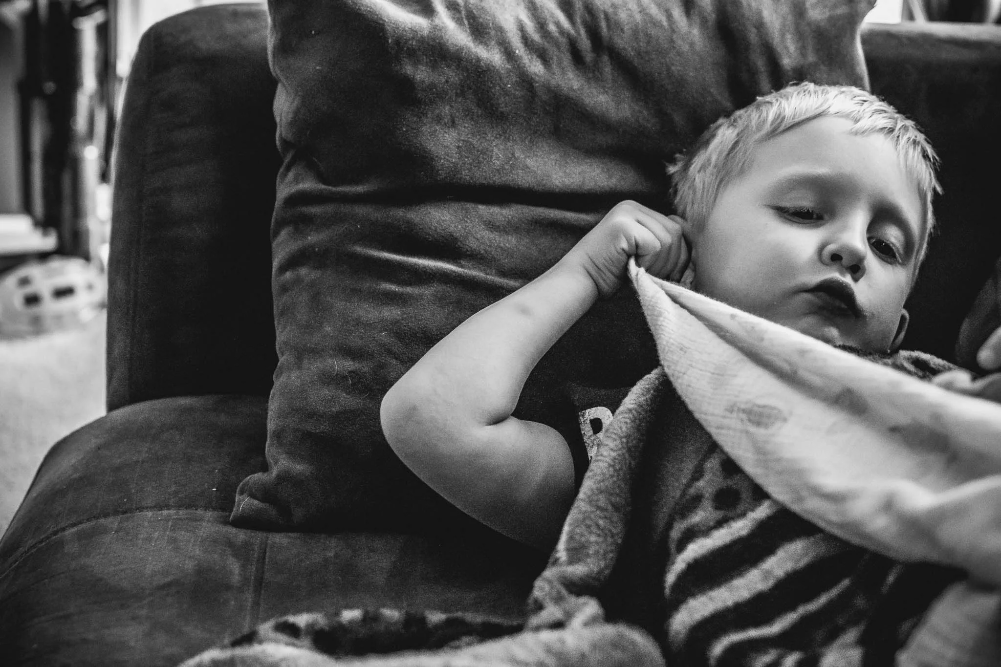 Totally not the perfect image. But the details here are what matter to me. He was tired and he took his blankie (one of 5, as long as they are muslin fabric he doesn't care) and rubs it in and along his ear. It's his tell that he is exhausted. Since he could touch his ear that was his thing.