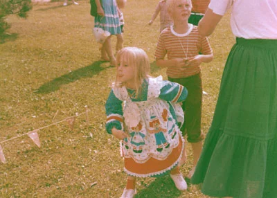 This about sums it up. Sticking my tongue out, in a pretty dress that my mom sewed herself.