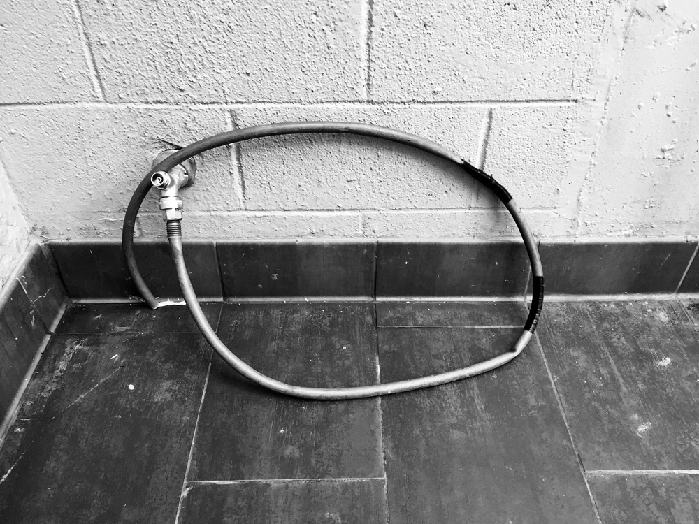  This utility hose located near the ground floor stairwell of a downtown parking garage is often used by Austin’s transient community for freshening/refreshment. 