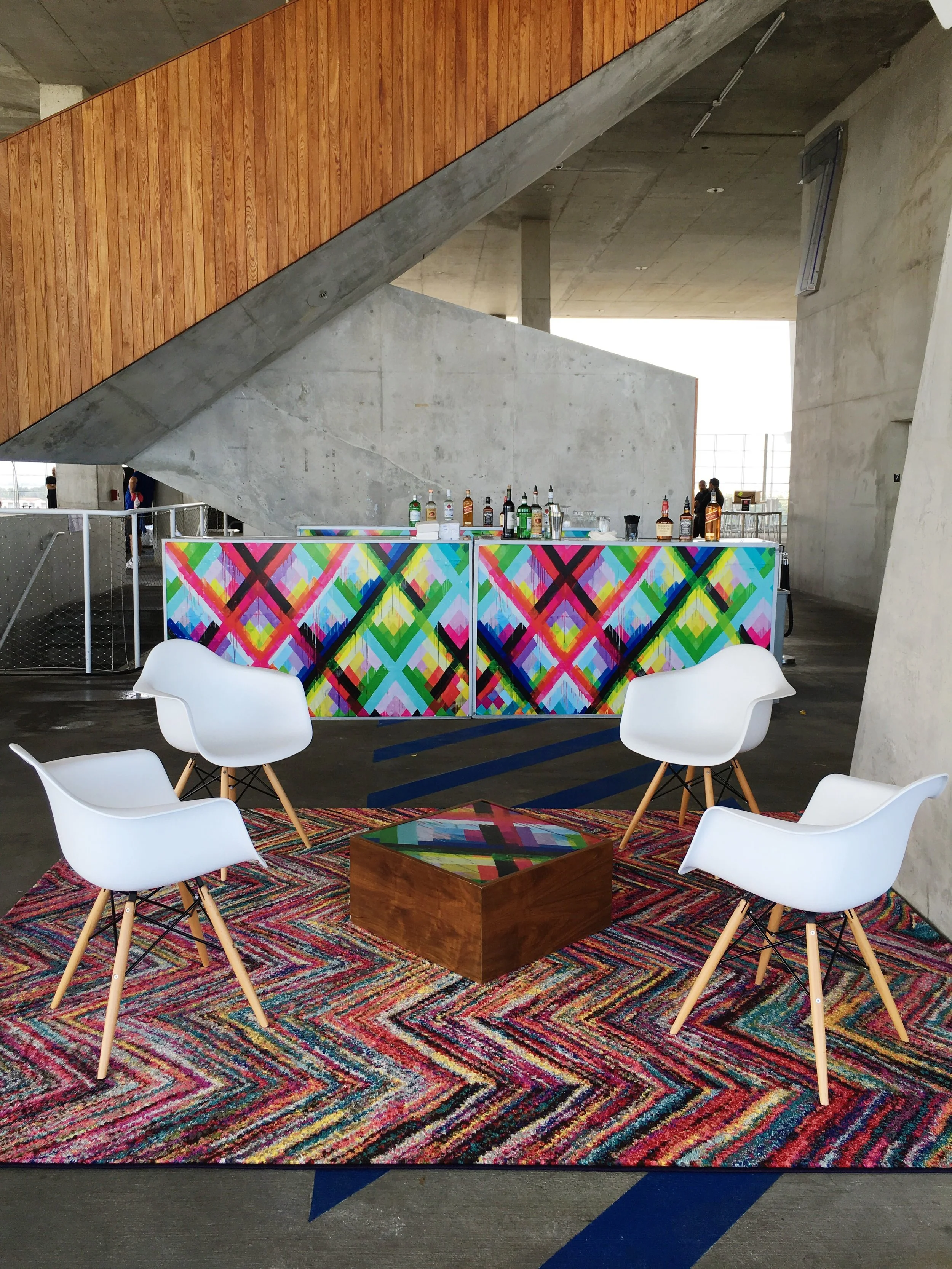 Eames chairs set together on a carpet for a brand activation event in Miami
