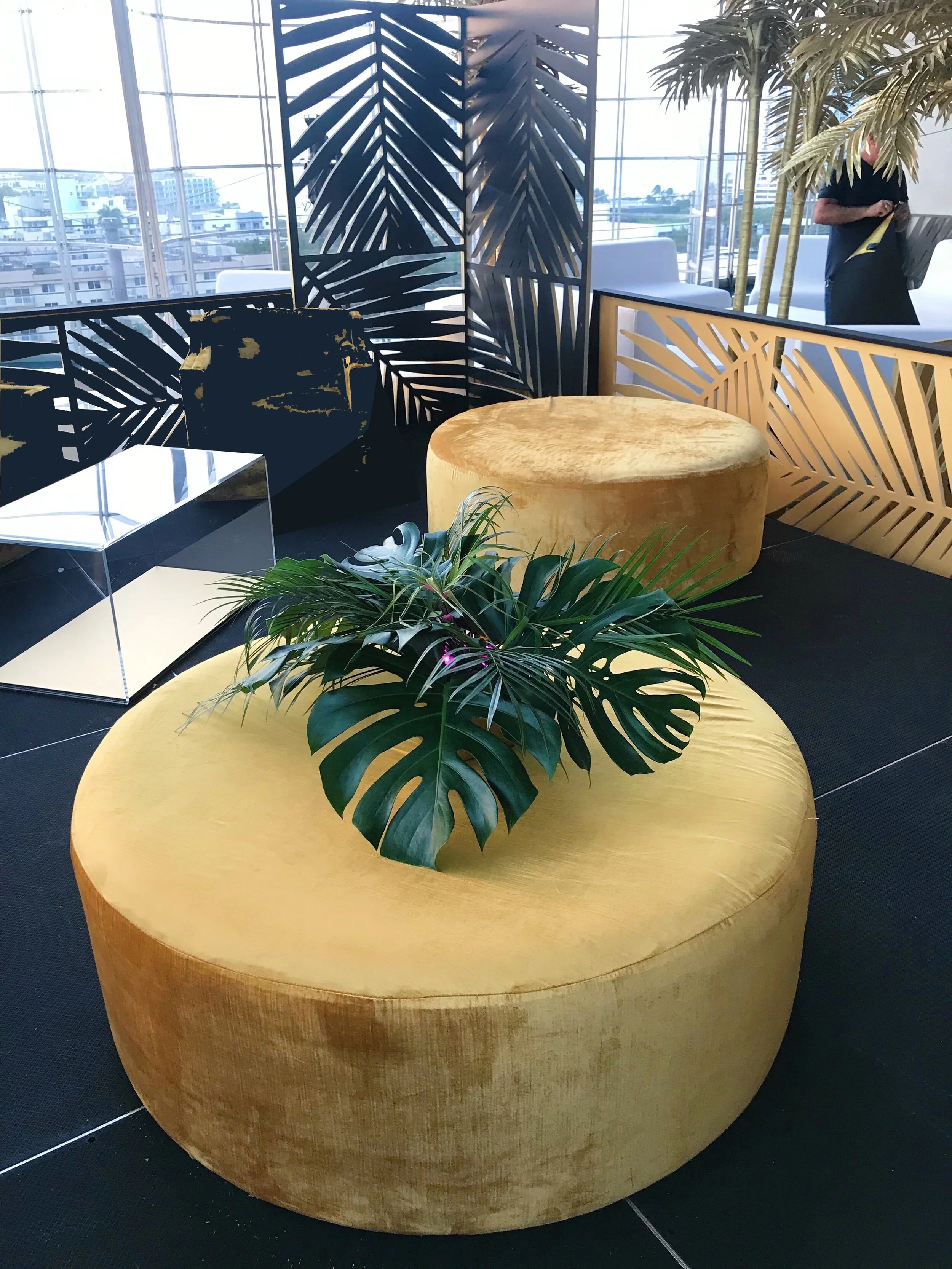 Gold velvet ottoman with tropical leaf
