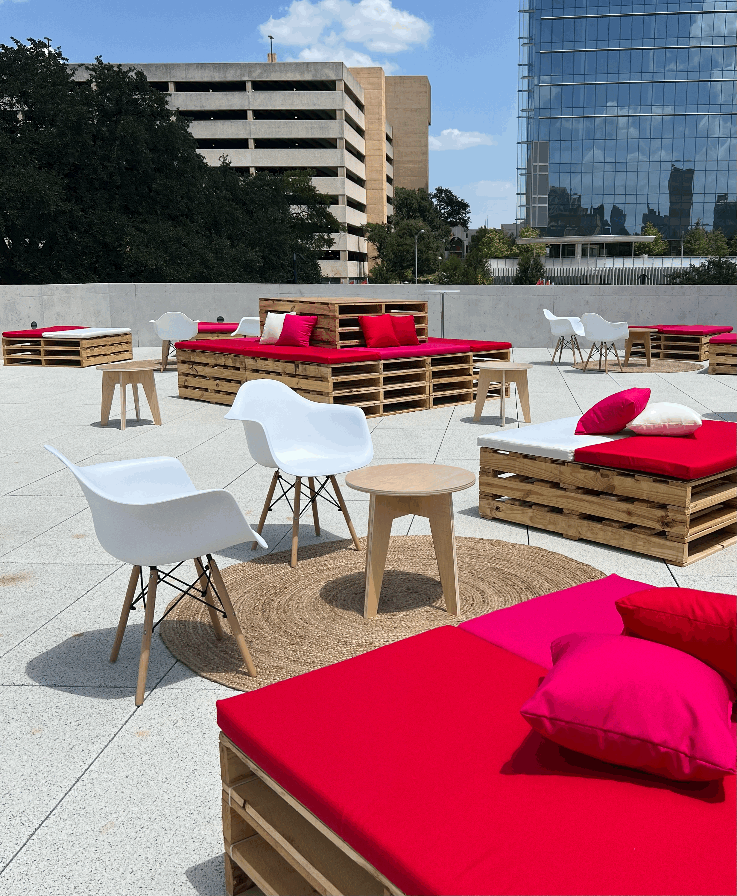 Eames chairs next to pallet beds at a VIP lounge in Austin