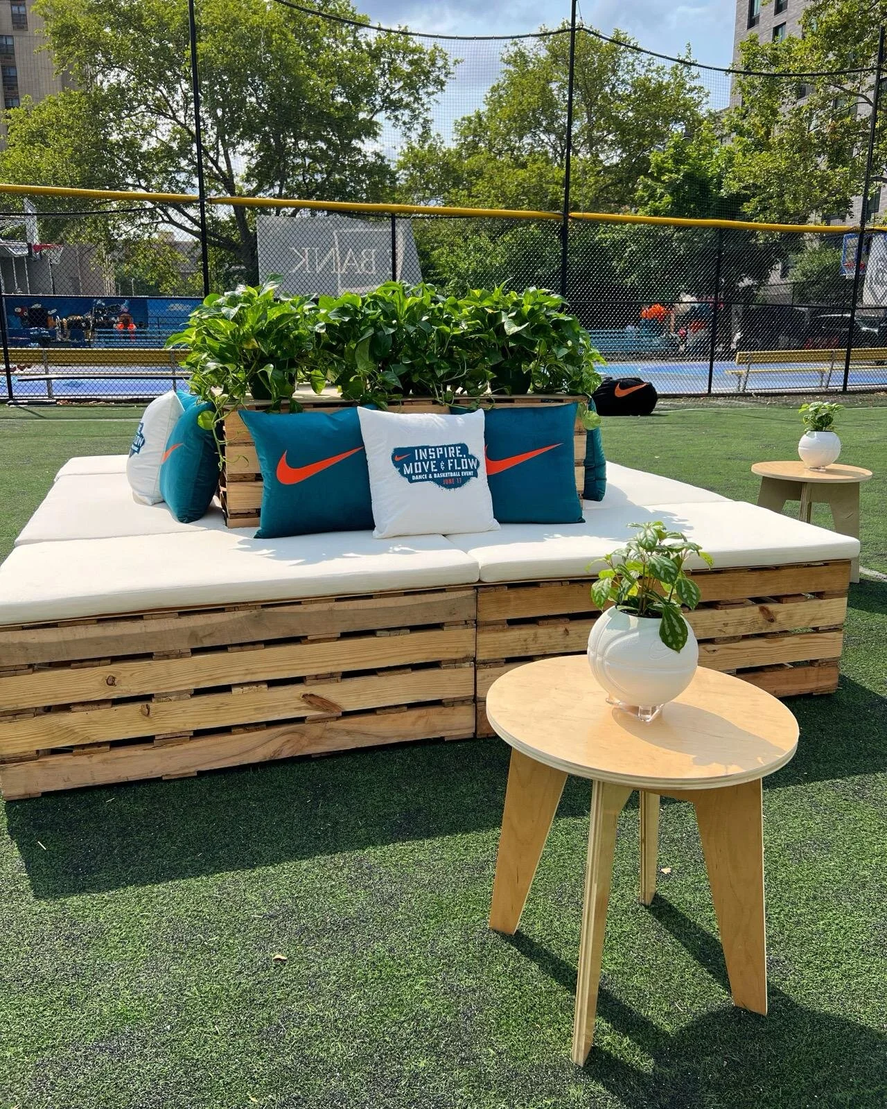 Island pallet furniture with branded pillows for an outdoor event in New York City