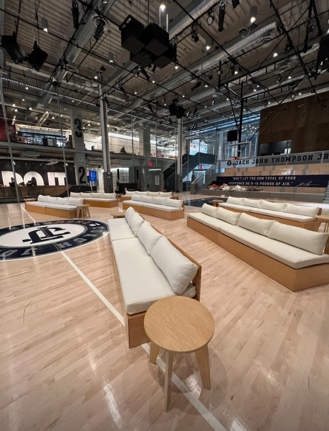 Rental sofas set together on an indoor basketball for an event in New York City