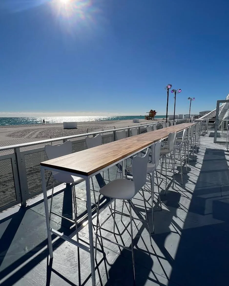 Nothing beats a good outdoor set up in Miami when the weather is perfect and the view is stunning 🌊☀️
Network and dine on our Modern Oak top Ella tables and white barstools. 
#eventfurniture #eventrental #meetingsandevents