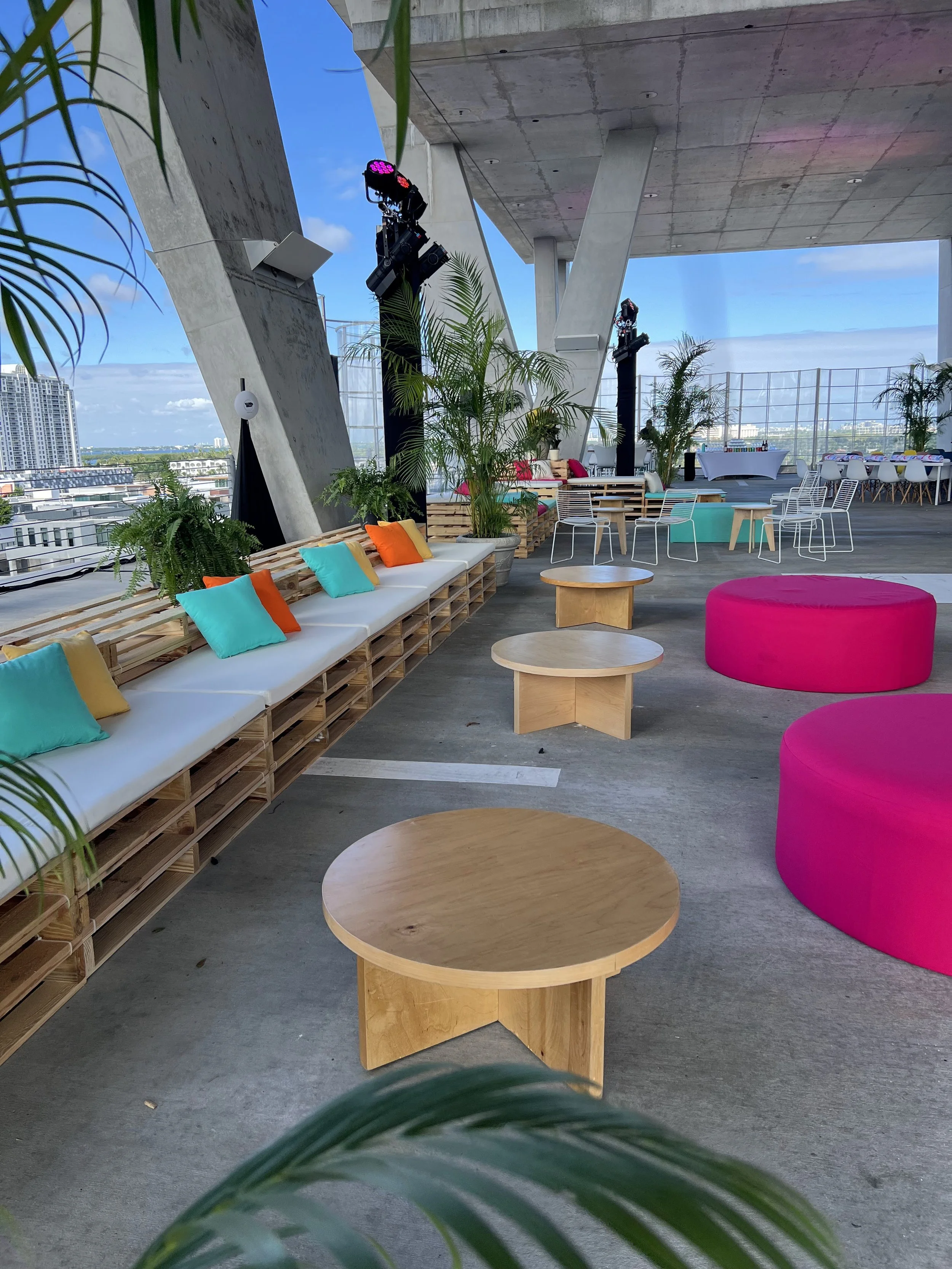 Sideline View Pallet furniture lounge at the 1111 building in Miami with colorful cushions and pillows