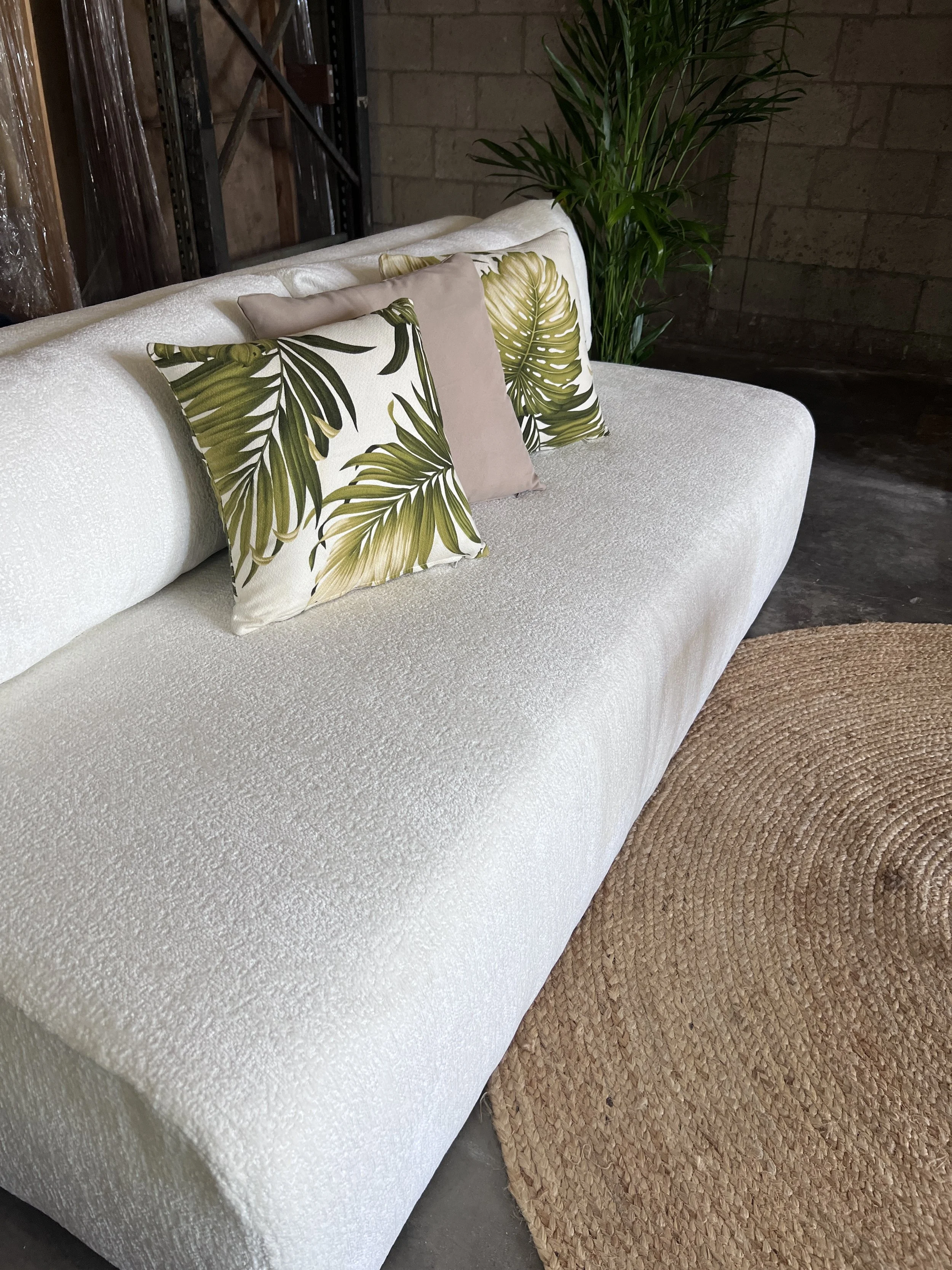 White elegant sofa for rent with tropical pillows