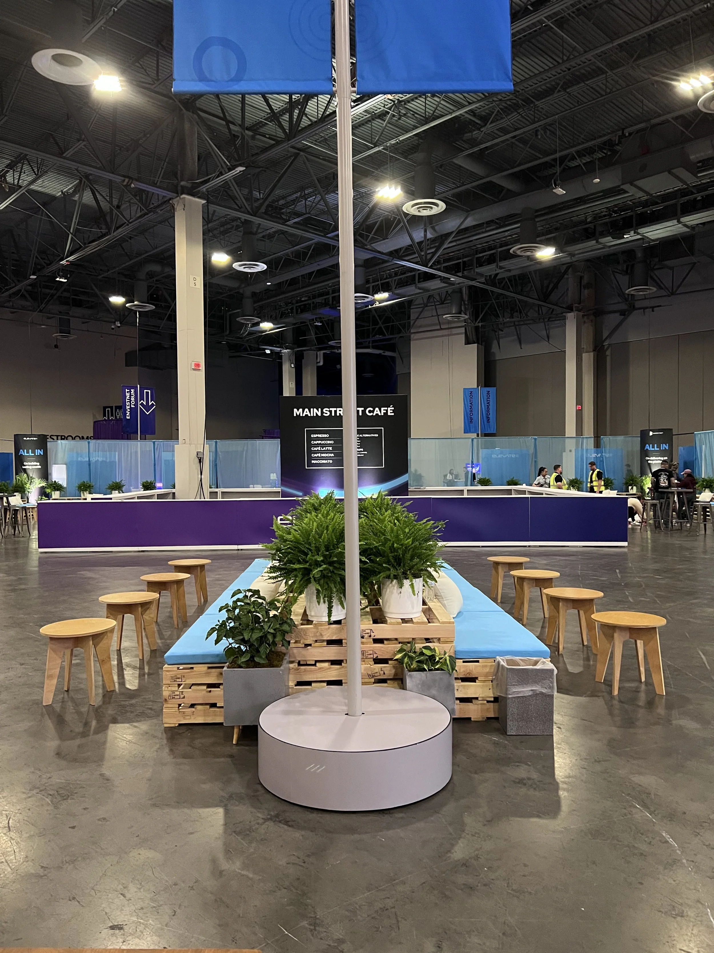 Pallet furniture in a back to back configuration with blue seating cushions place along conference floor in Las Vegas