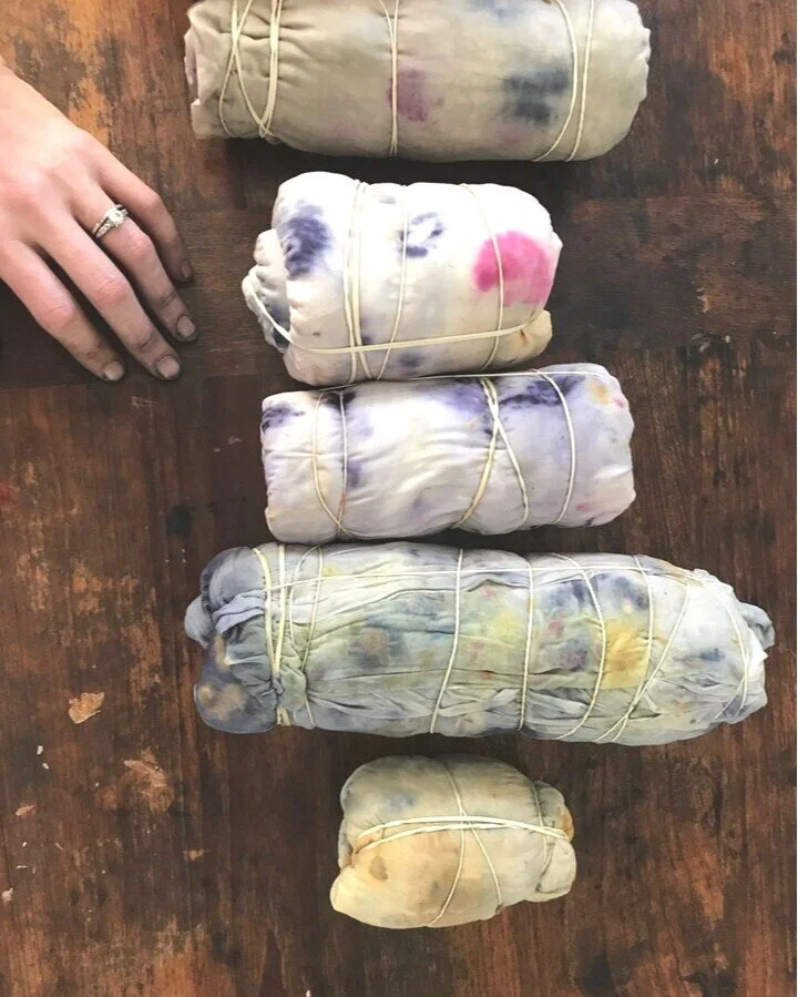 Hands dyeing fabric with flowers and natural dyes with an eco printing technique.