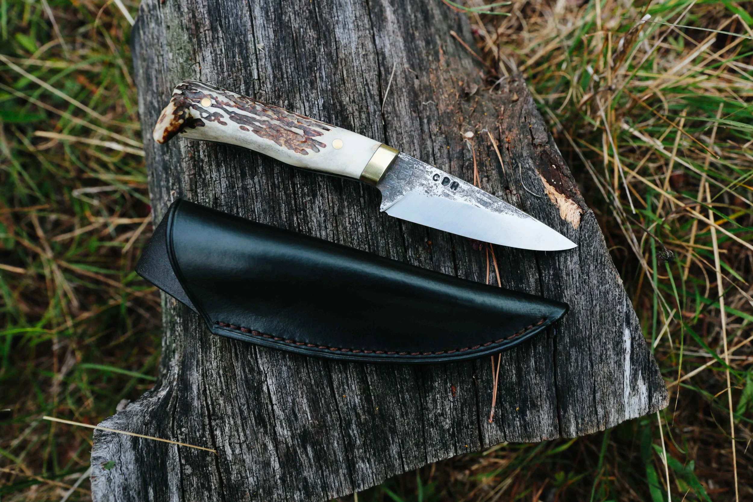 Forged Drop Point Skinner in white tail shed & brass.