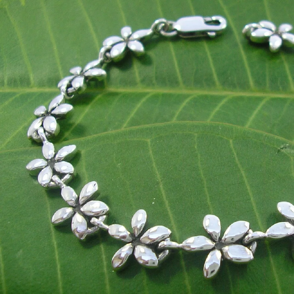FrangipaniBraceletOnLeafs1000.jpg