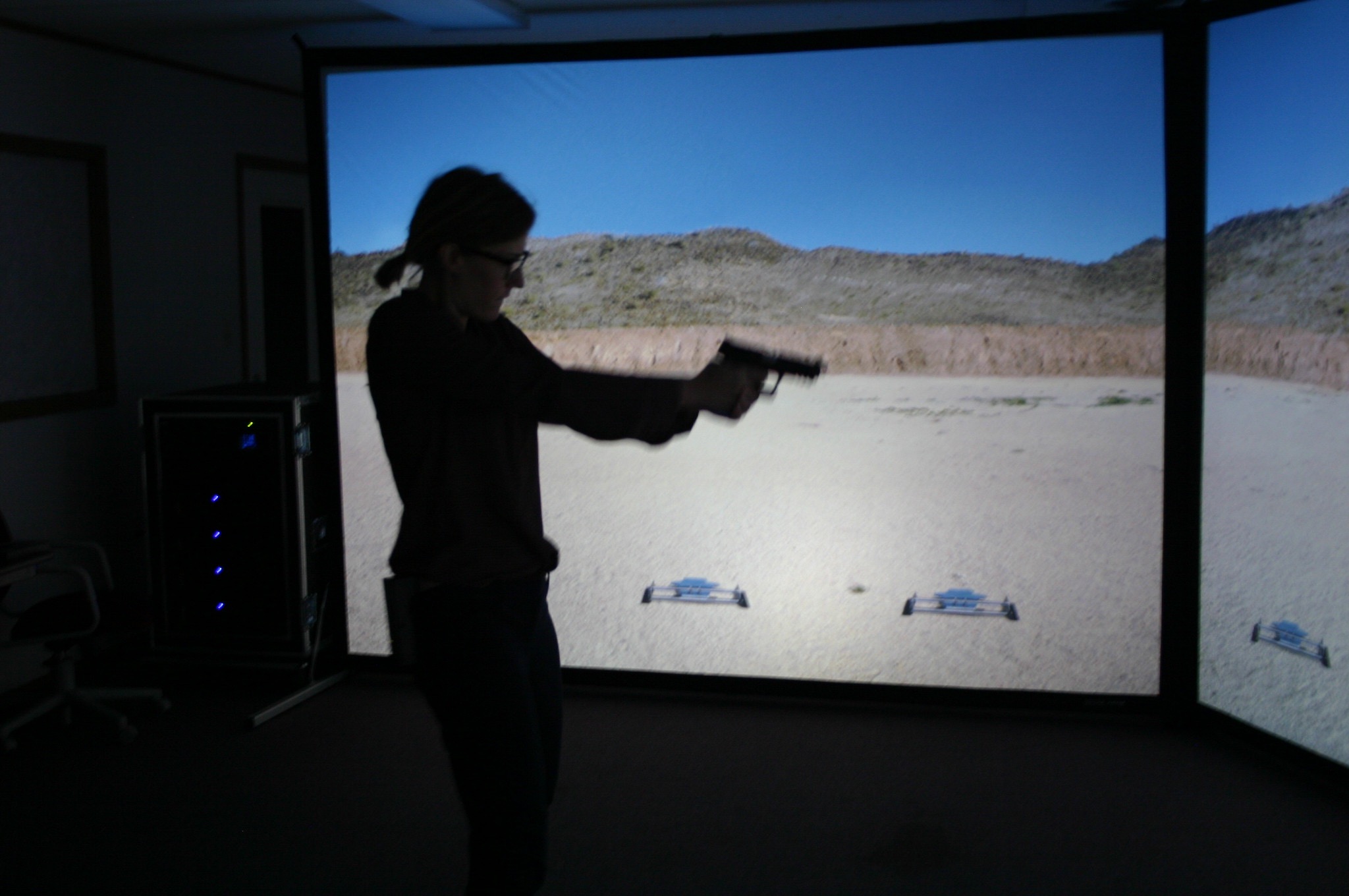 A participant uses the VIRTRA trainer which project images on a 180 degree screen. 