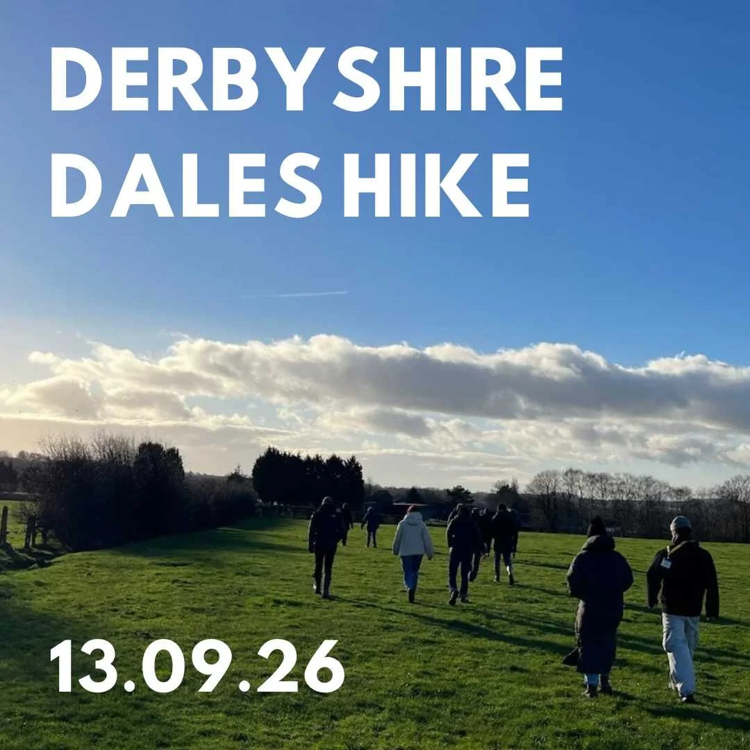 A group of people walk across a green field, with a cloudy blue sky. The text overlaid says 'Derbyshire Dales Hike, 13.09.26'