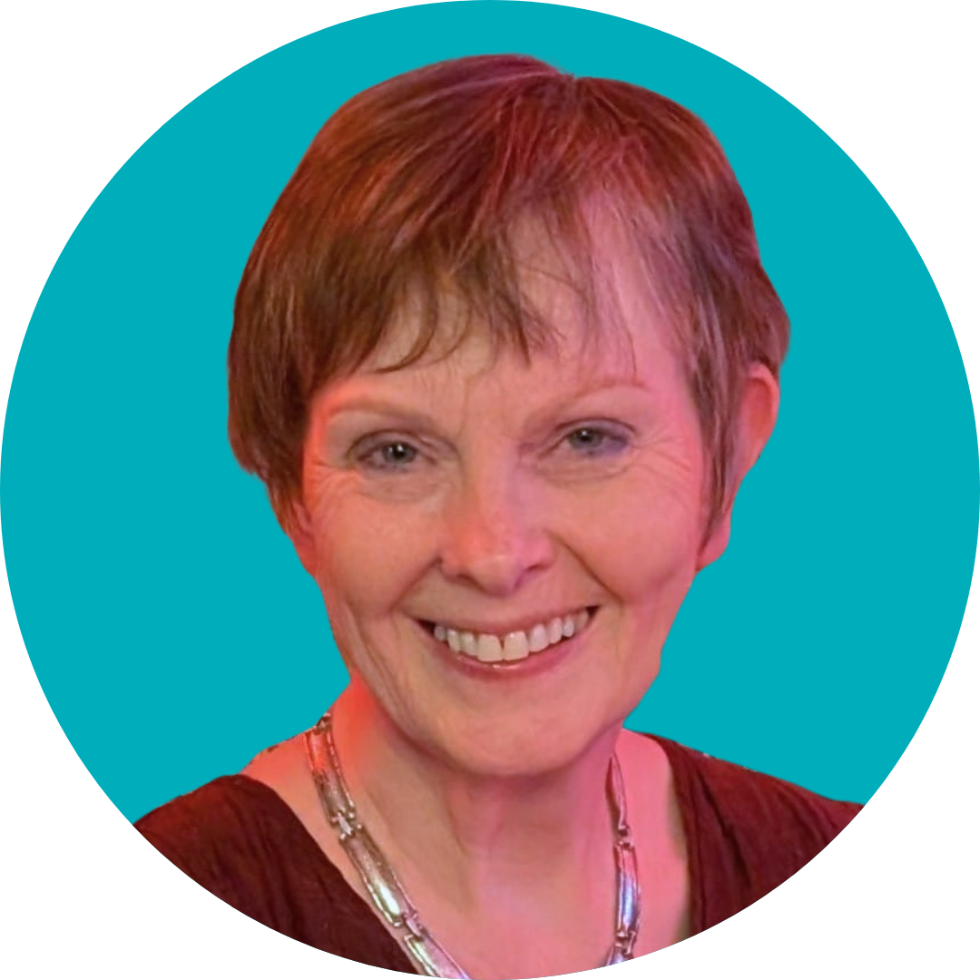 A woman with short grey hair smiles at the camera. She is wearing a necklace and a red top. She is set against a teal background.