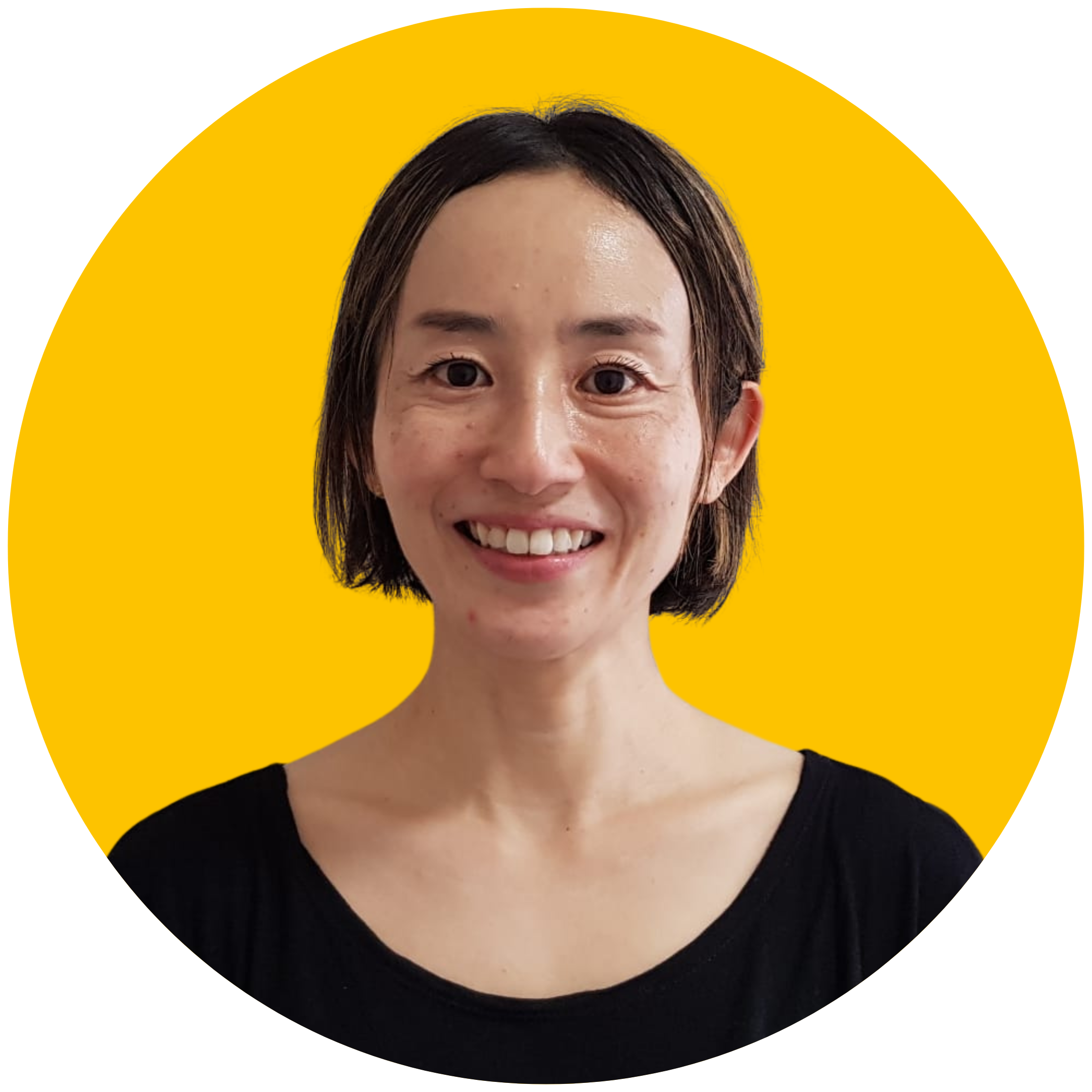 A woman with short brown hair smiles at the camera. She is wearing a black top and is set against a yellow background.