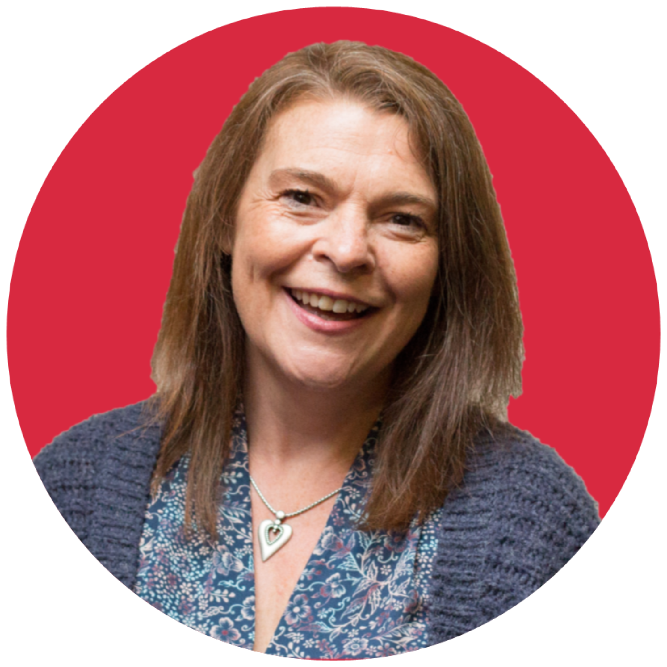 A brown-haired woman smiles at the camera. She is wearing a grey cardigan and is set against a red background.
