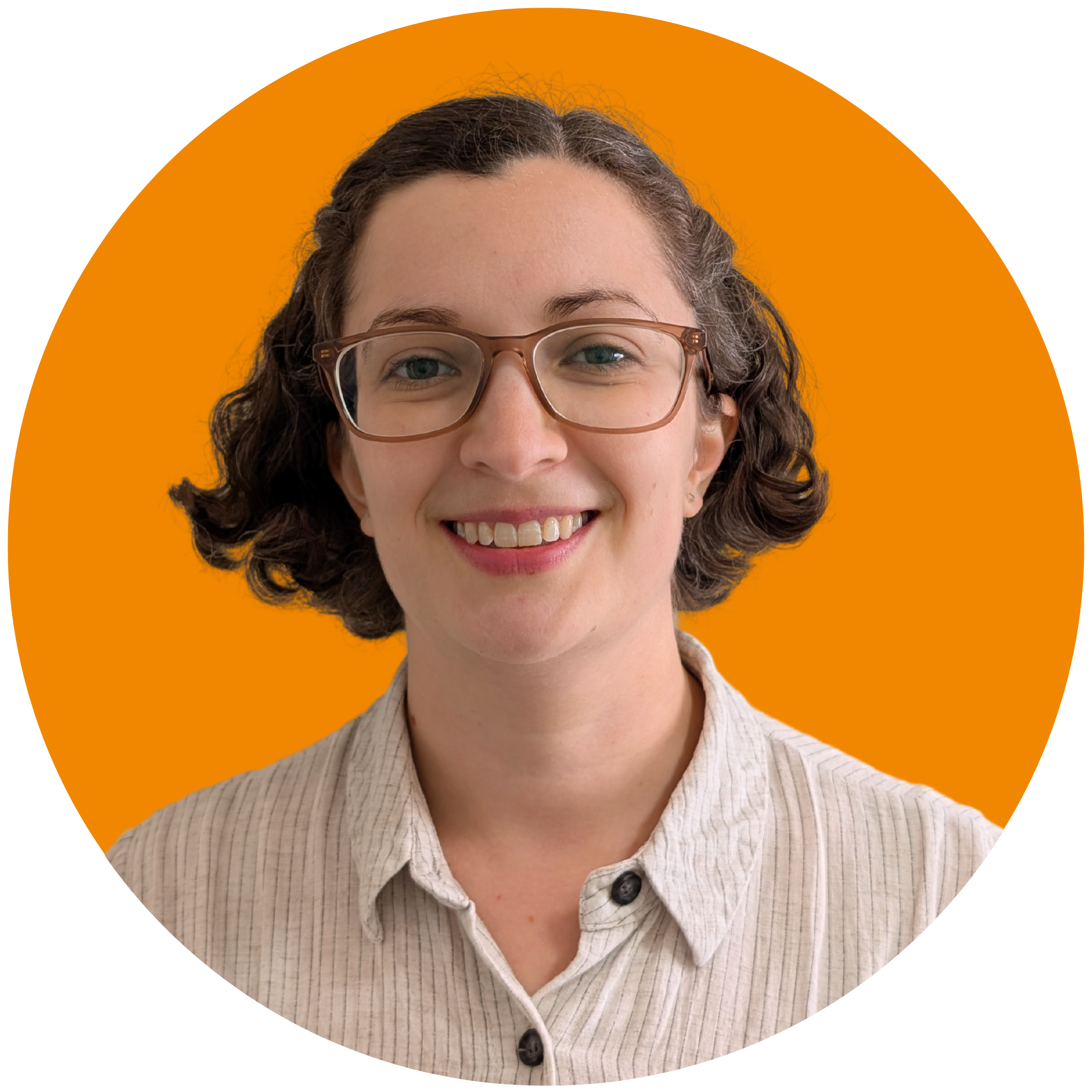 A woman with short brown curly hair smiles at the camera. She is wearing glasses and a white striped shirt, and is set against an orange background.
