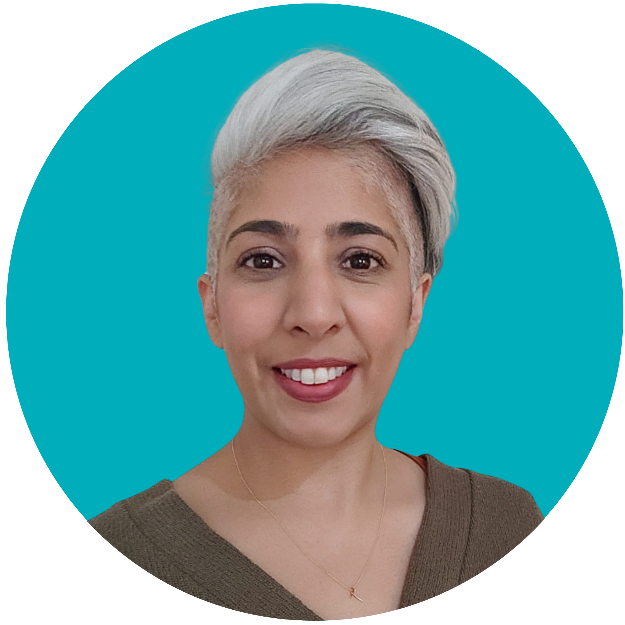 A woman with short grey hair smiles at the camera. She is wearing a green top and set against a teal background.