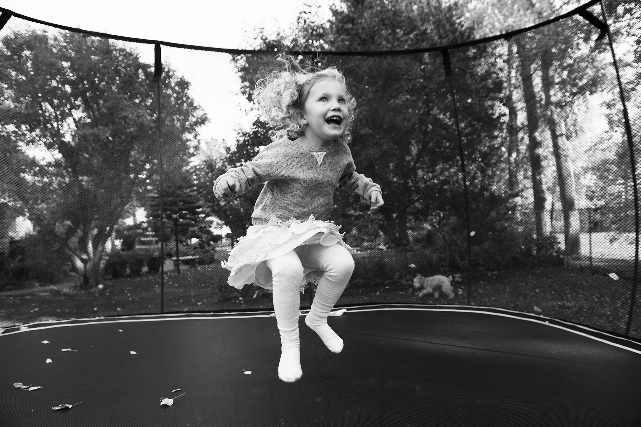 Black and white portrait of girl jumping on a trampoline.jpg