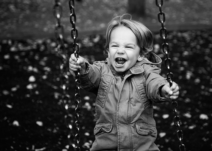 Black and white portrait of young boy on swing.jpg