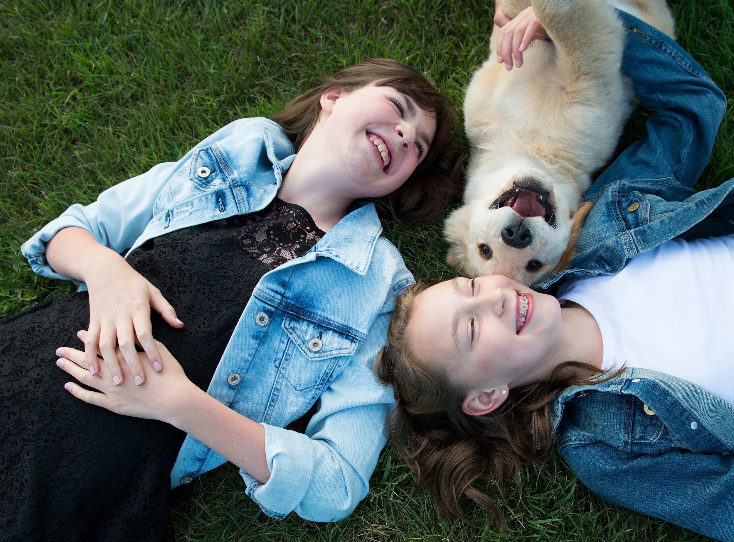 Girls and dog laying in the grass.jpg