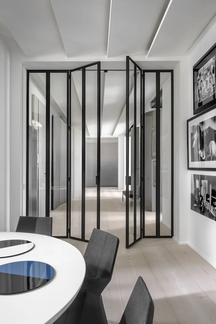 The Trocadero apartment, Paris. Doors in glass and polished steel by Pounat, bronze and corona table by Eric Schmitt, chairs by Konstanin Crcic