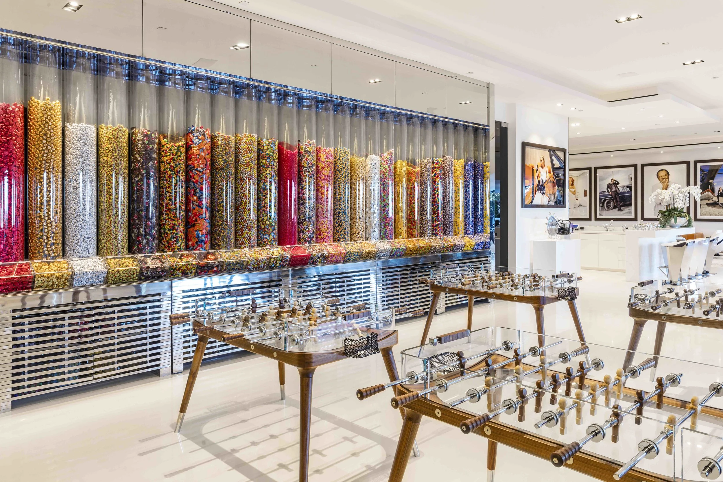 The ground floor includes custom glass ping pong and foosball tables, as well as a wall-mounted candy dispenser 