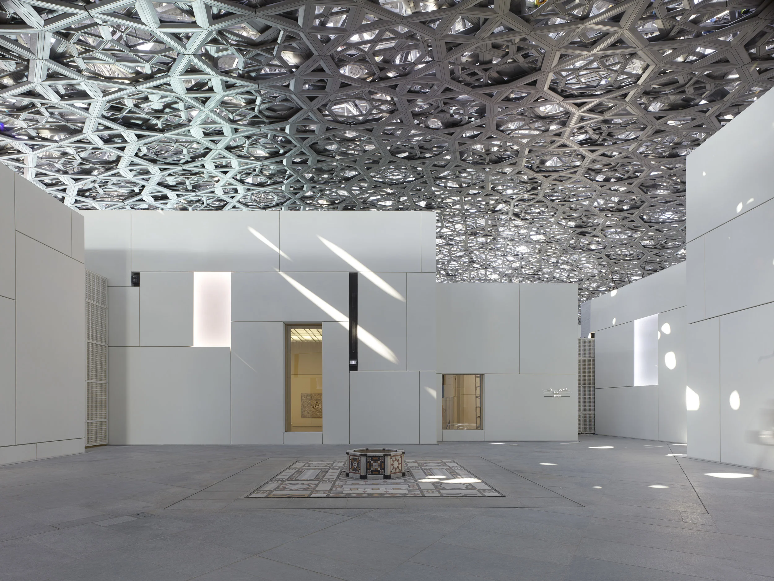 The combination of shade and airflow reduces the ambient temperature of the courtyard