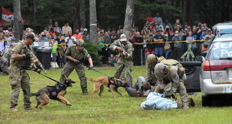 A SEAL team demonstrates the tactics they use to stop a fleeing vehicle during a demonstration of their combat readiness held Saturday as part of Swim with a Mission at Wellington State Park. (Bea Lewis/Sunday News Correspondent)