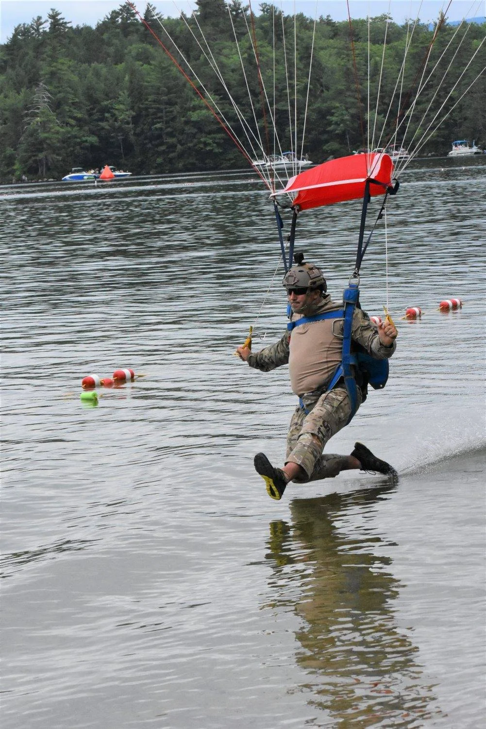A Navy SEAL touches down in Newfound Lake on Saturday, close to the beach at Wellington State Park as part of Swim with a Mission. (Bea Lewis/Union Leader Correspondent)