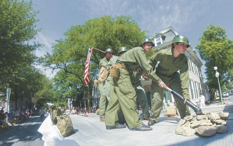 Boy Scout members replicate the flag at Iwo Jima on their float during Lewisburg's 4th of July parade on Saturday.