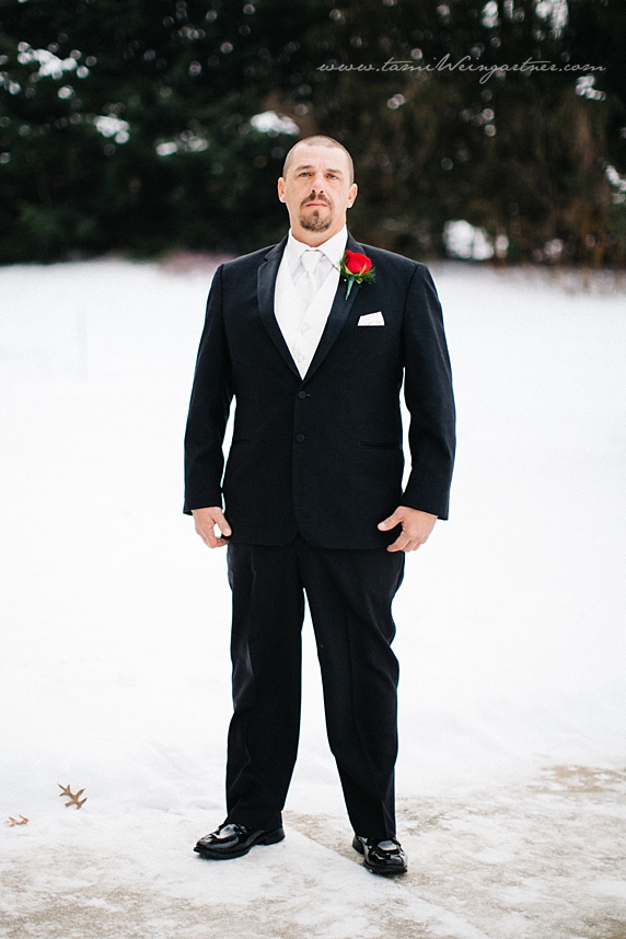 Black tux and white tie on groom for December wedding