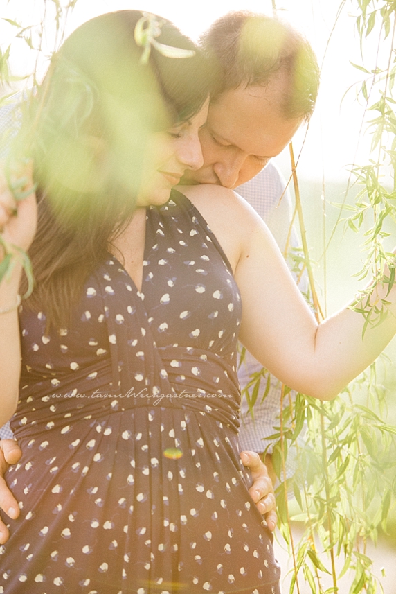 Gorgeous romantic light on a couple in a willow tree