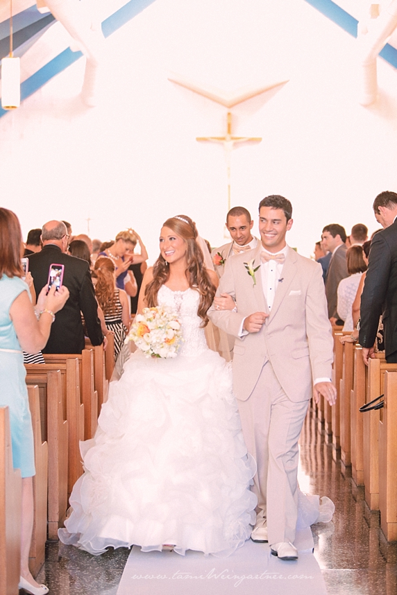 Happy couple walking back down the aisle at St. Anthony's Catholic Church in Bessemer PA.