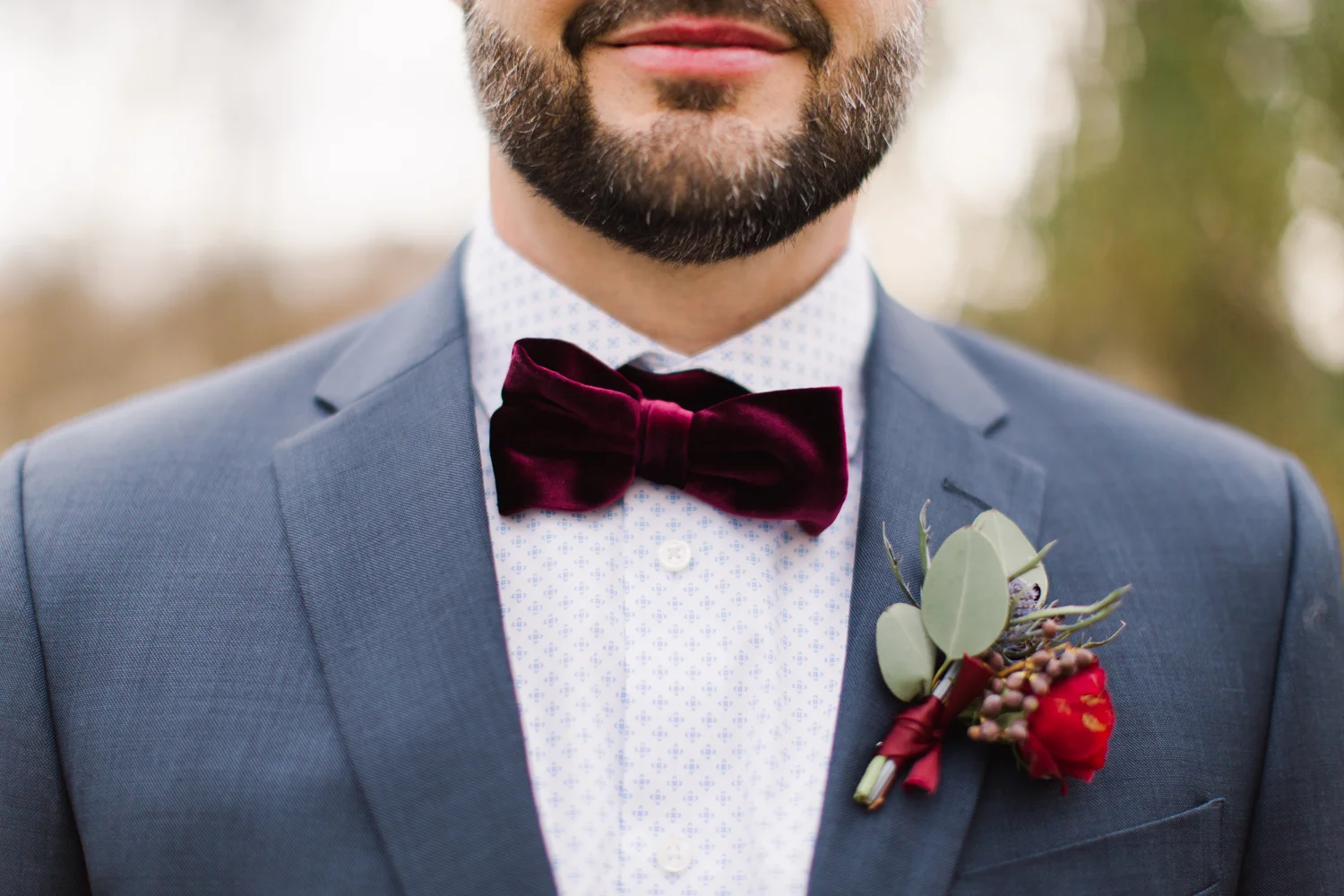 Grooms Details with patterned shirt and velvet bow tie.