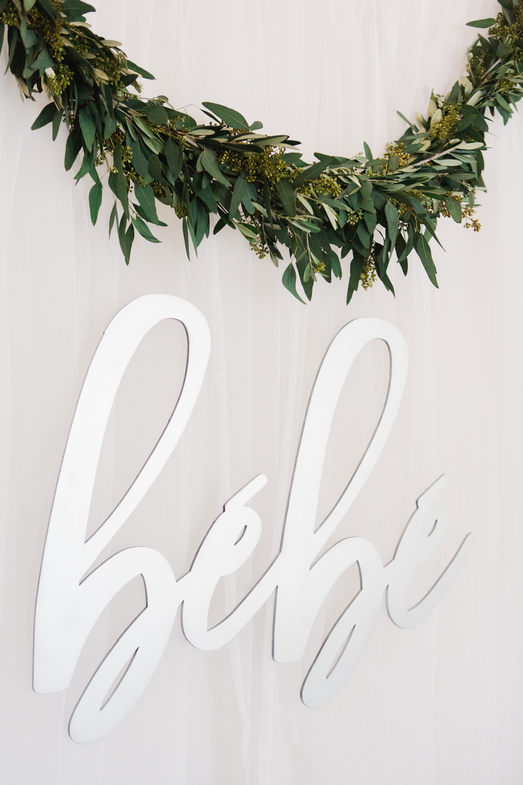 cutout silver bebe sign with a second eucalyptus swag over the brunch buffet