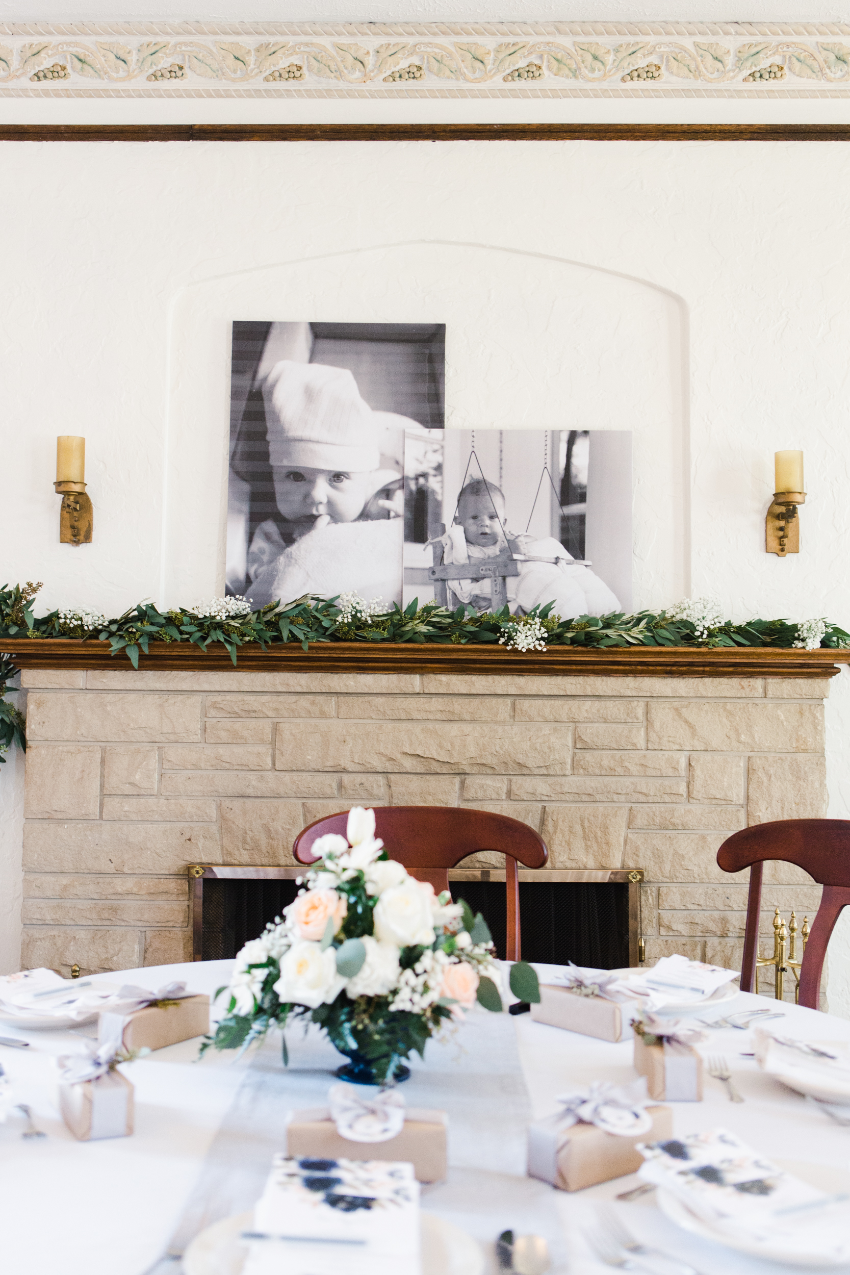 Eucalyptus swag on the fireplace mantle along with large black and white engineer prints of the couple as babies