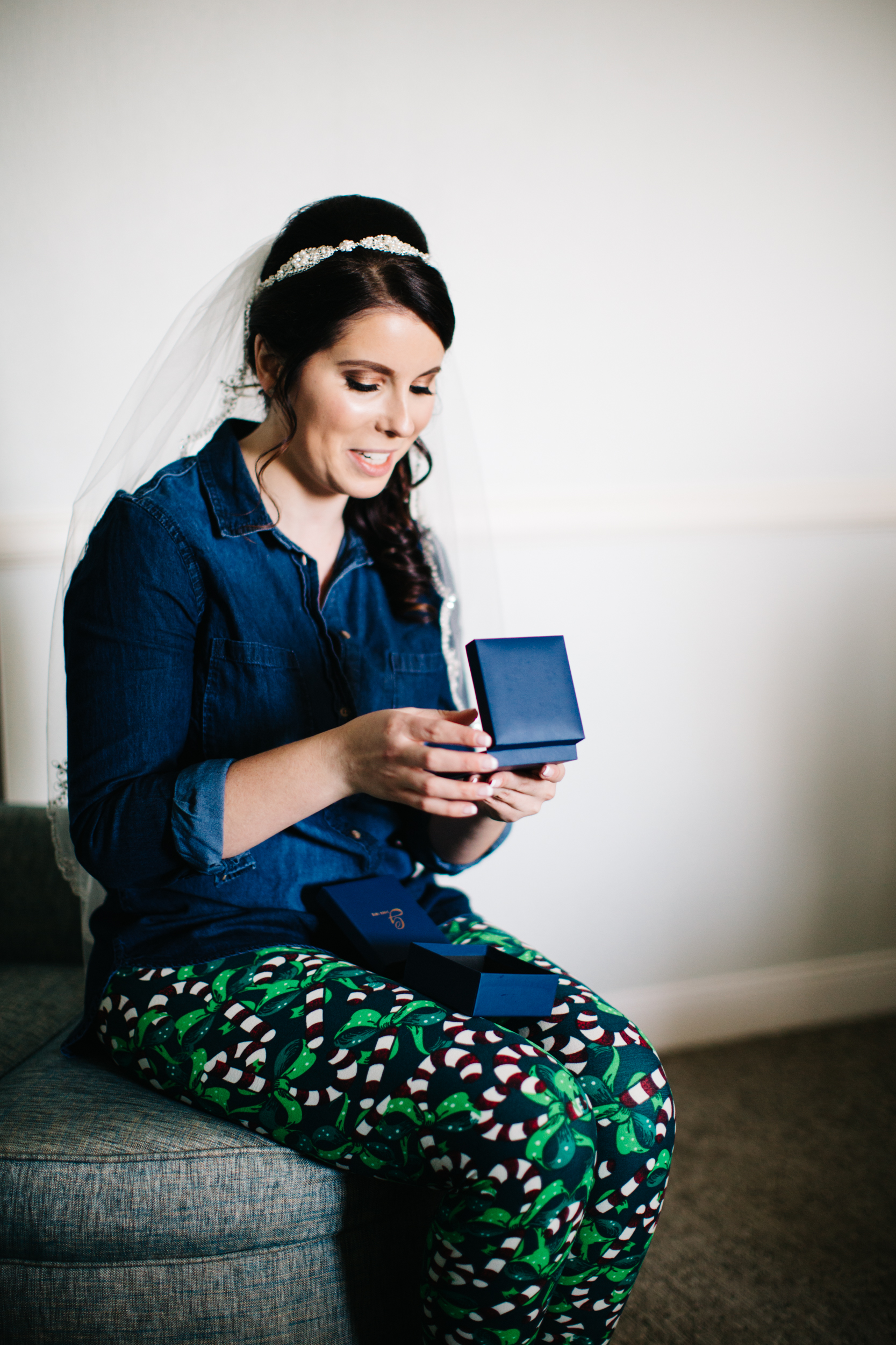 Bride opening a Goldstock jewelry diamond solitaire pendant which was a gift from the groom.