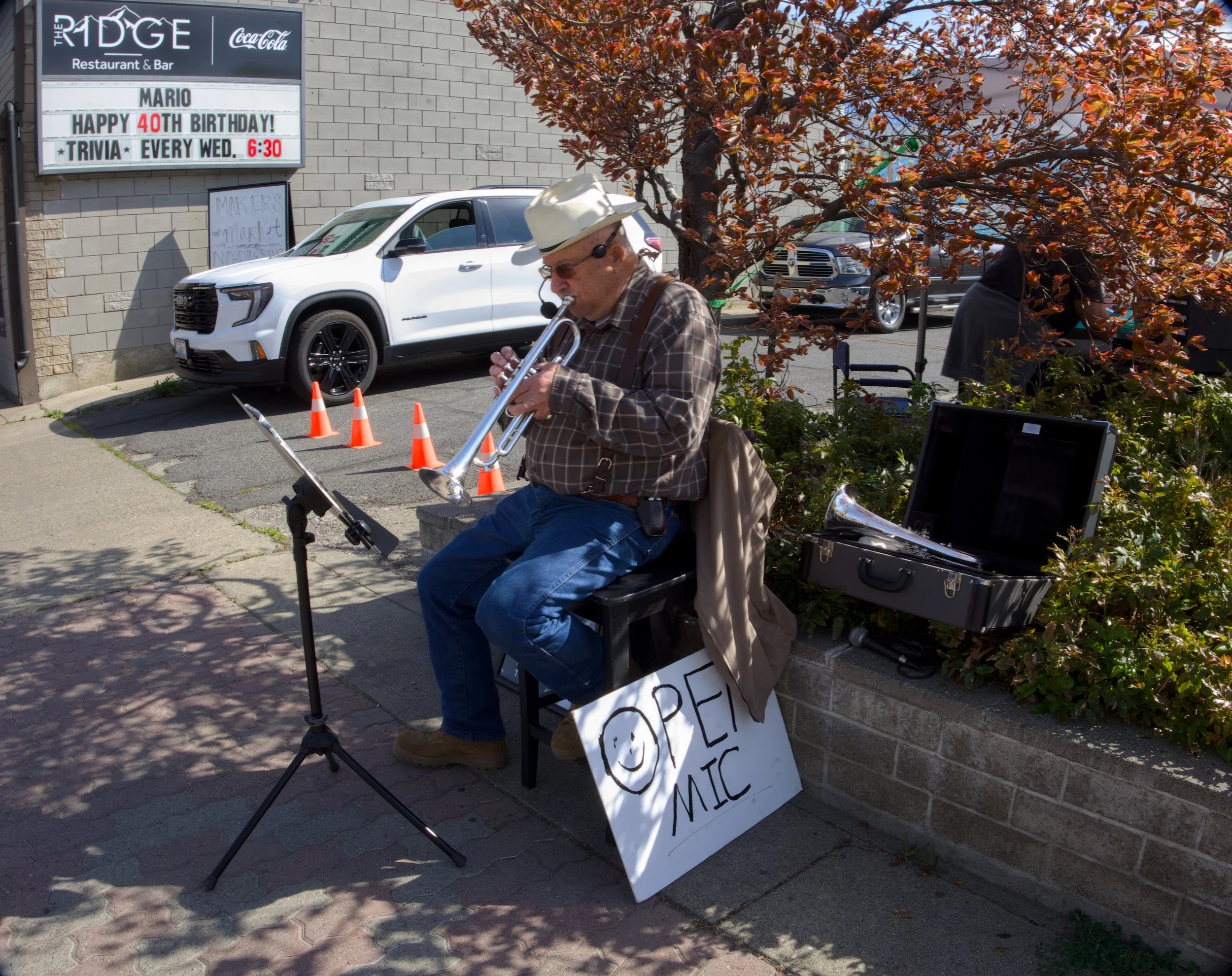 Musician busks and plays trumpet at Farmers' Market opening day2.jpg
