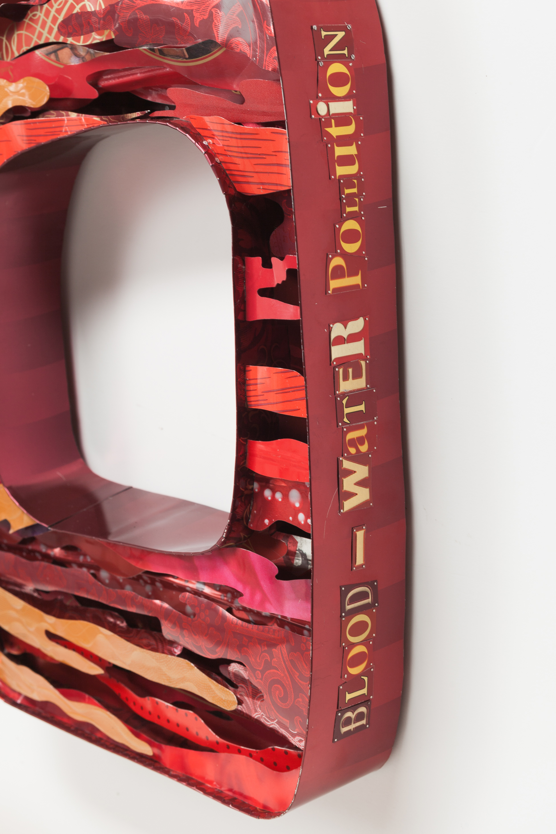 Side view of Blood - Water Pollution and the Need to Provide Clean Affordable Water by Harriete Estel Berman from recycled tin cans.