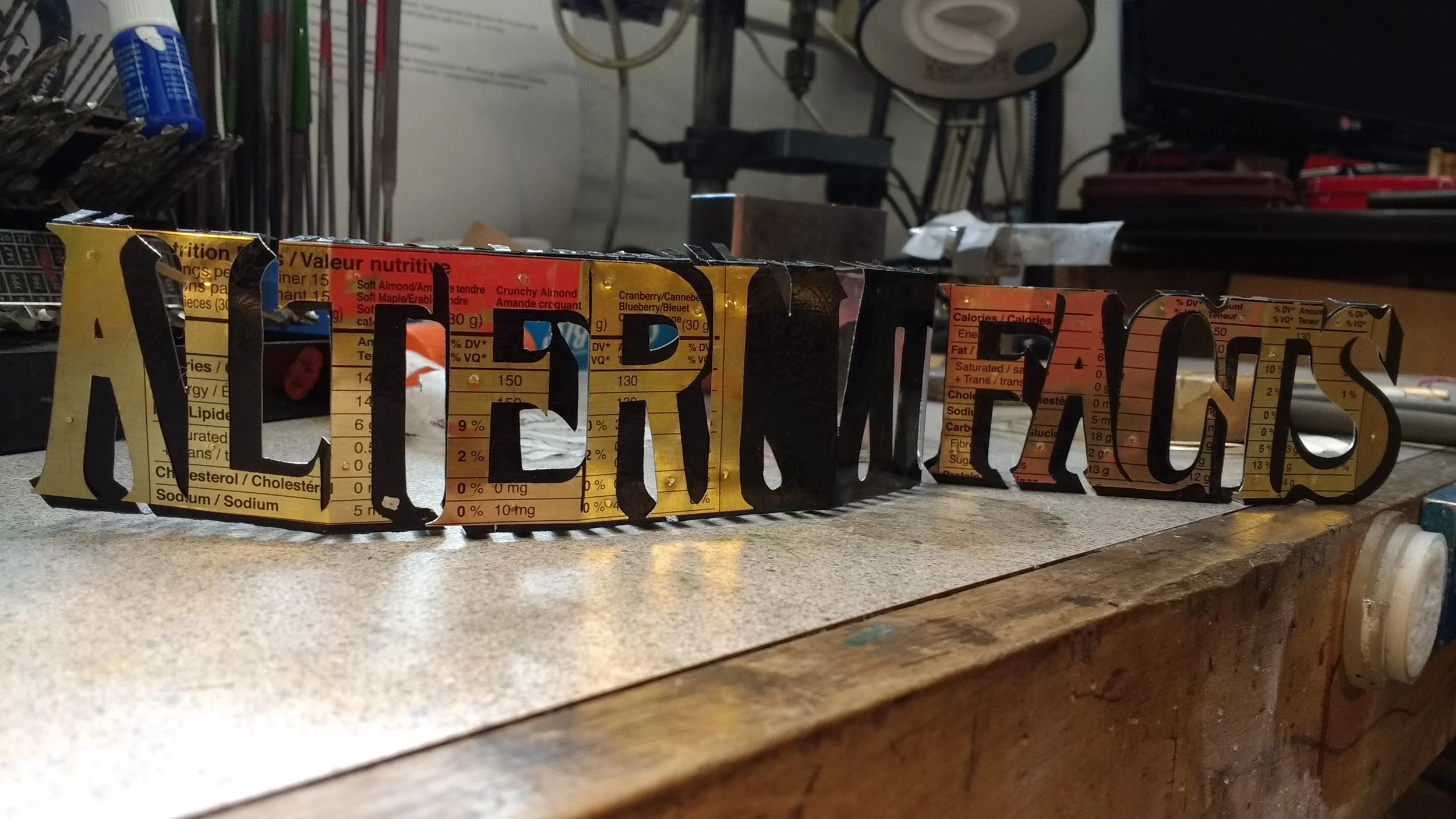 ALTERNATIVE FACTS is a bracelet cut from recycled tin cans. The insubstantial construction is a metaphor for the lies, and half truths from the 45 administration. 